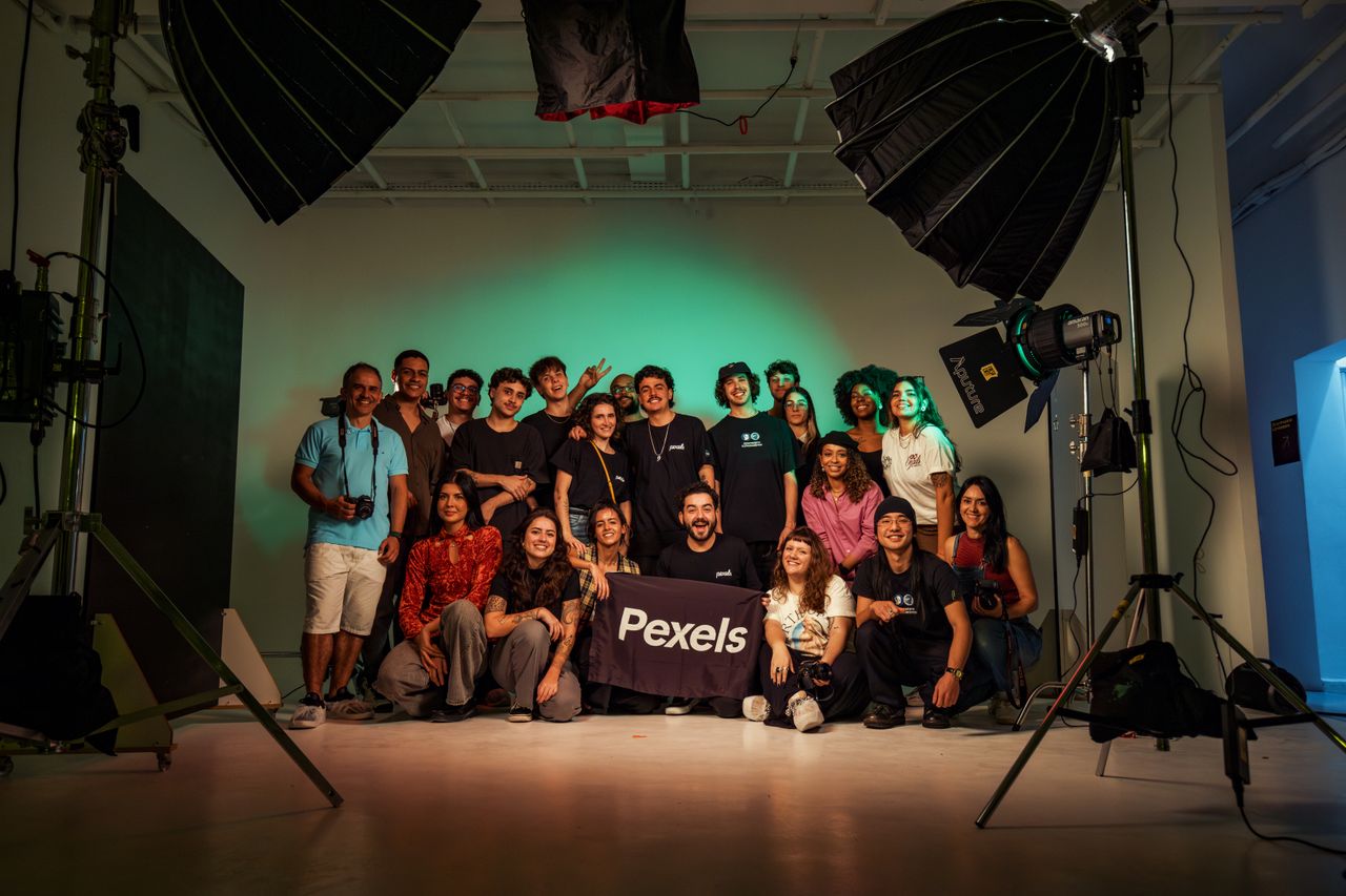 A varied group of adults posing in a professional photography studio.